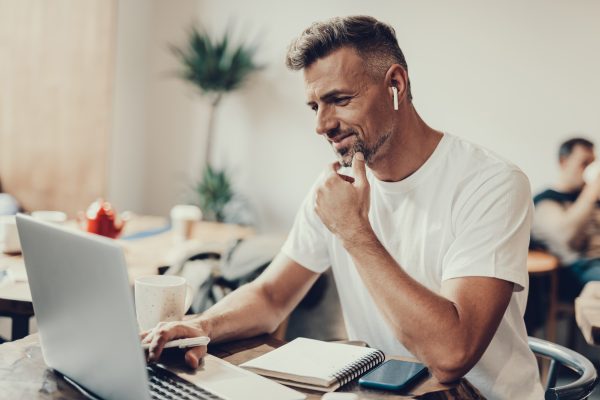 man-working-from-home-using-laptop-and-notepad-2026-09-25-02-24-28-utc